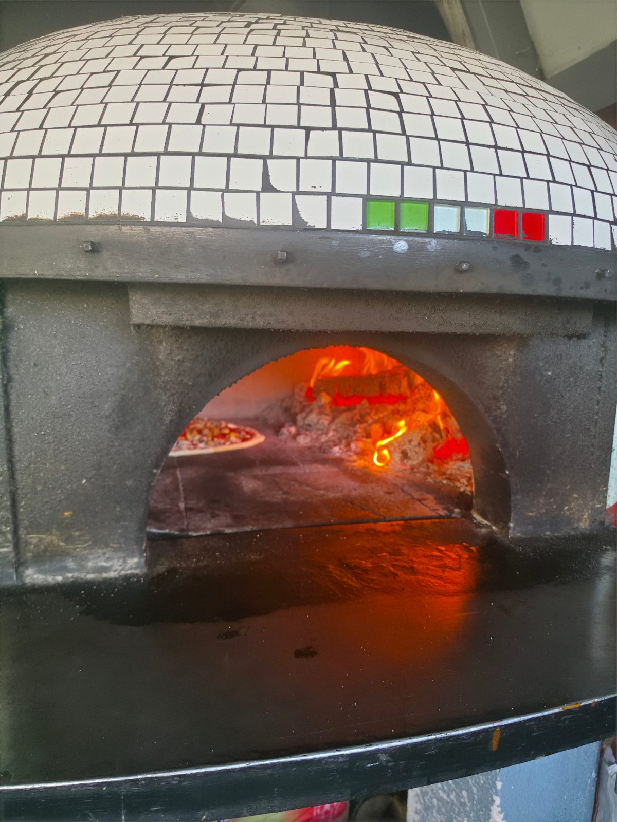 Piec opalany drewnem z pizzą wypiekaną w żywym ogniu